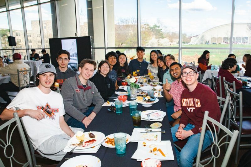 Students pose for the camera in a dining hall. 