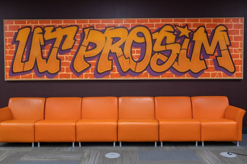 A picture of the Ut Prosim mural on the second floor of Newman Library.