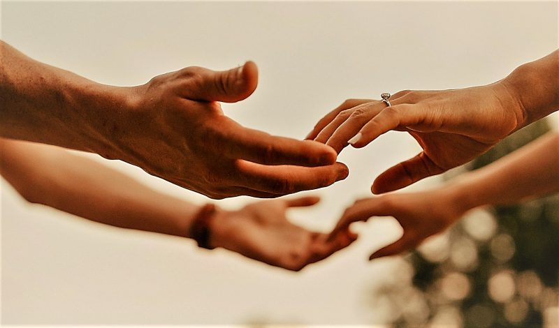 Photo of  the hands of two people reachingfor each other