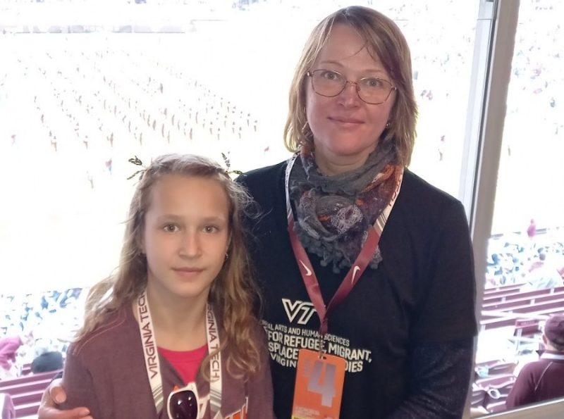 A woman and her daughter embrace for a photo at a Virginia Tech sporting event.