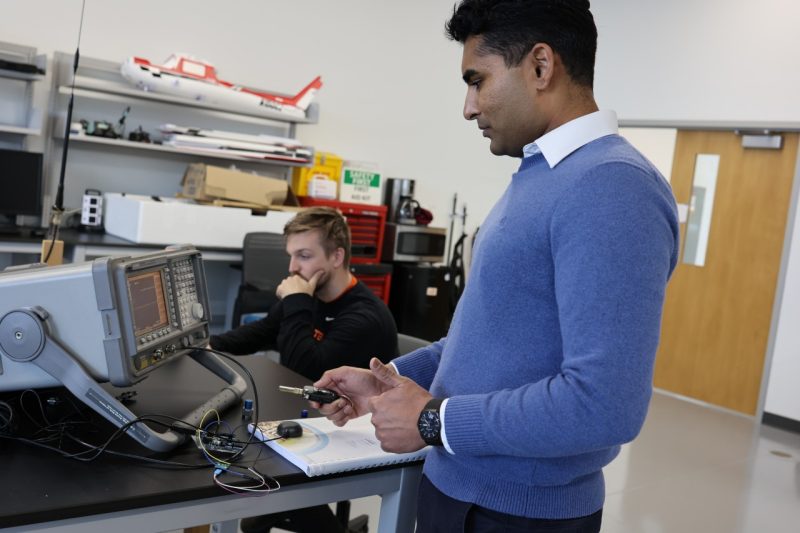 Sandeep Jada (right) and Casey Smith test sources of signal interferences in Mathieu Joerger’s Assured Vehicle Autonomy (AVA) Lab. 