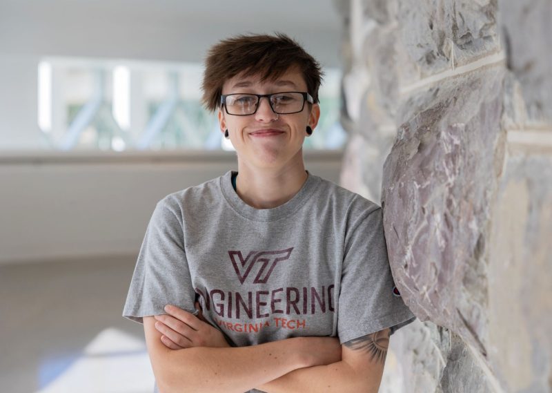 Smiling photo of electrical and computer engineering graduate, Hayley Wisman, in the Moss Arts Center.