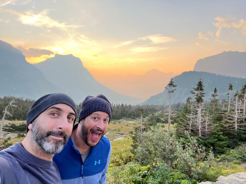 Andrew Gorman 1 Two people at Glacier National Park with the sunrise in the background.