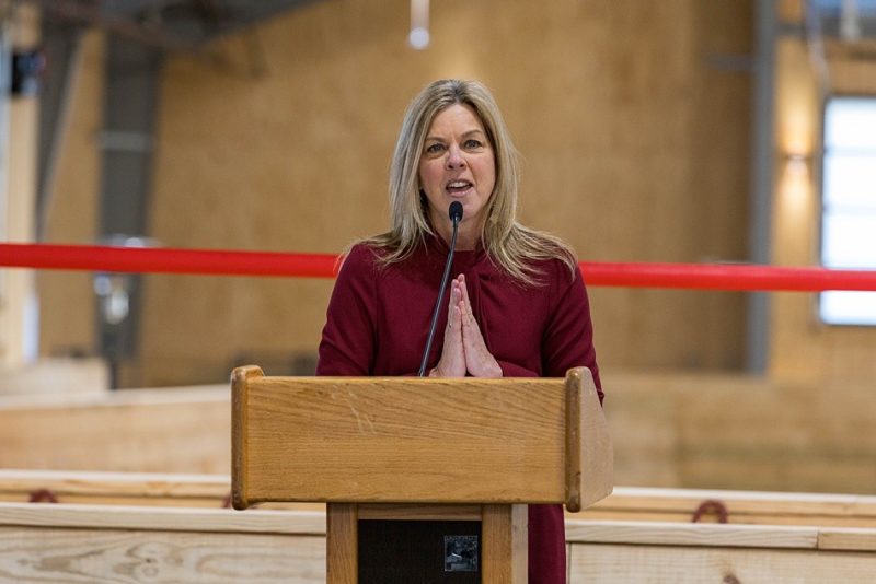 Person speaking in front of a podium.