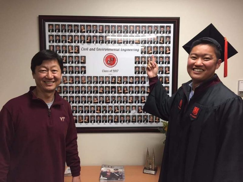 Young Ho ‘87 and Justin Chang ‘17 smile with the class of 2017 composite.