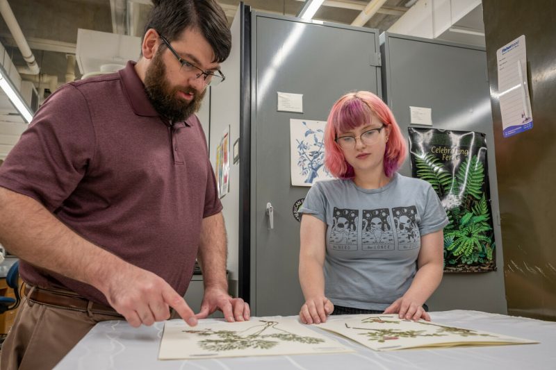 Jordan Metzgar with student at the Massey Herbarium