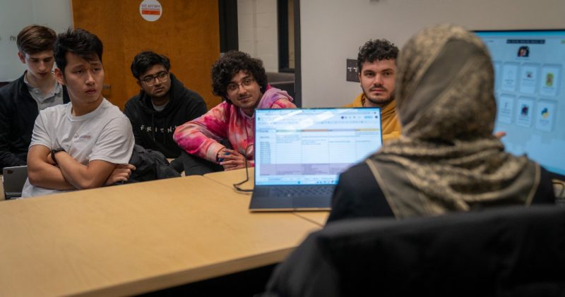 Part of the undergraduate project team working on Code Kids with Sally Hamouda in the foreground.