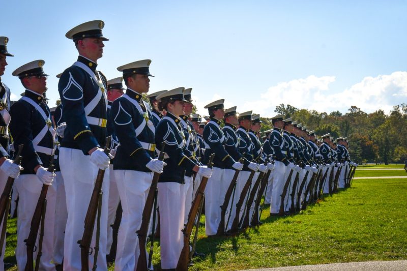 A large group of cadets stand in full dress uniform on the Drillfield at parade rest during the Homecoming Pass in Review in October.