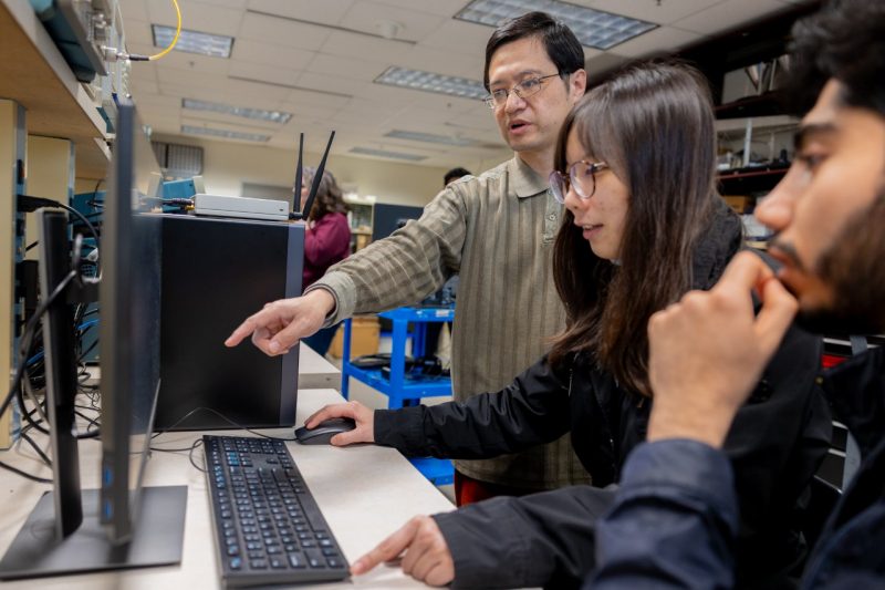 Lingjia Liu examines signal scatterplots with two of his graduate students. Photo by Ben Murphy for Virginia Tech.