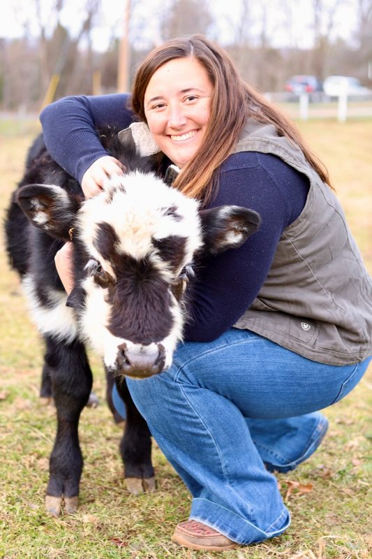 Morgan Sowers hugging a baby cow.