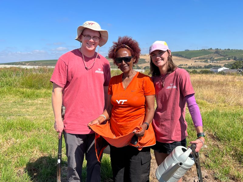 (from left) Joe Paterson, Ozzie Abaye, and Grace Bartlett take soil samples at the Living Soils Community Learning Farm in Lynedoch Valley, South Africa. Photo by Will Rizzo for Virginia Tech.