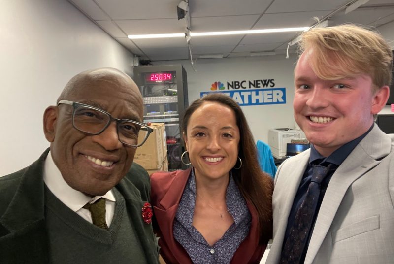 CNRE Shaw Prociv Roker Three people pose for a photograph in an office building.