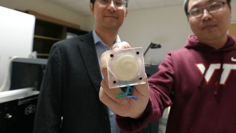 (From left) Assistant Professor Zhenhua Tian and student Teng Li show the emitter used to create an acoustic vortex. Photo by Alex Parrish for Virginia Tech.