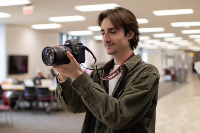 Jack takes photos in Newman Library's second floor commons area.