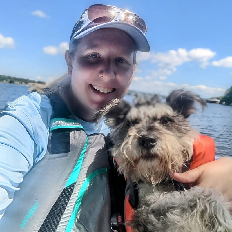 Ashley Briggs and her dog in life jackets.