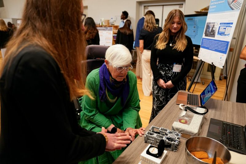 students speaking to professor in wheelchair