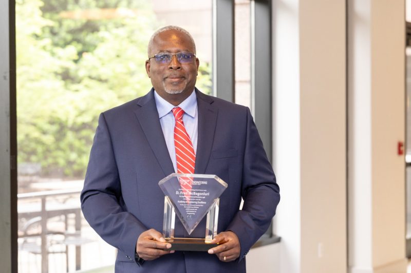 D. Fred McBagonluri with his Academy of Engineering Excellence award.