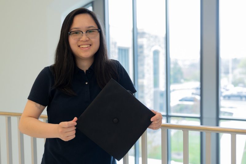 ECE - Jenny Li - Graduation Computer engineering student Jenny Li holds a graduation cap.