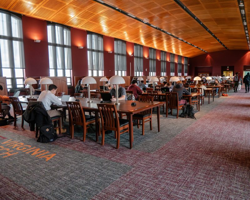 Students sit at tables to study in Torgersen Bridge. The carpet has been freshly replaced by the renovations team. 
