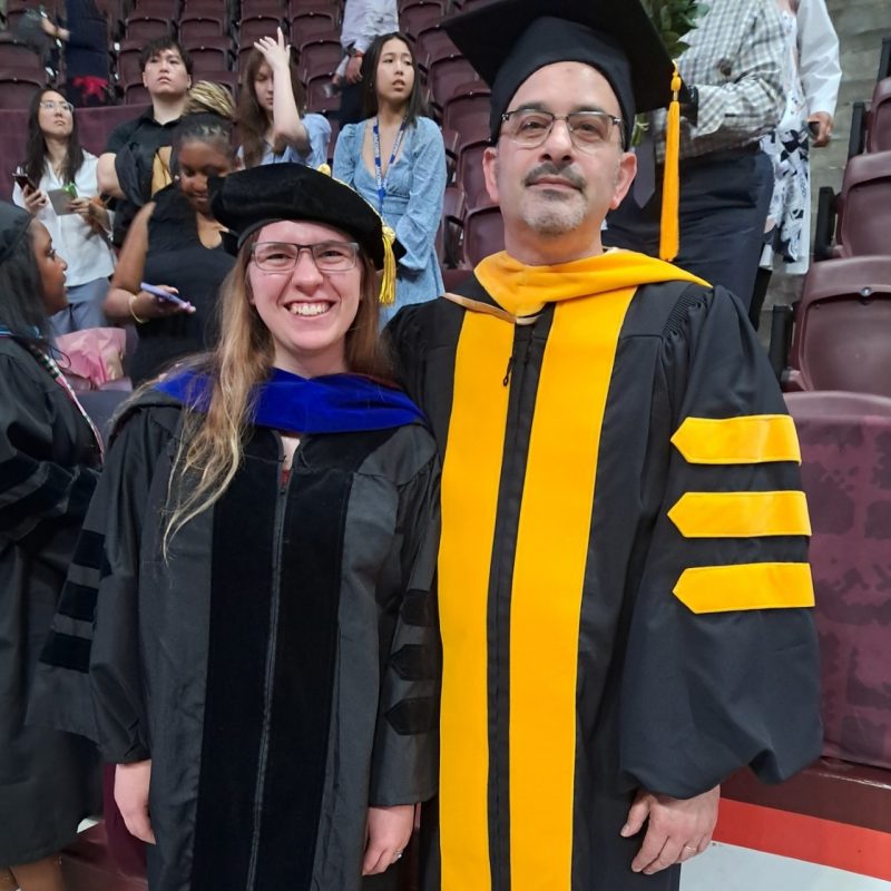Tiffany Roach, left, in graduate regalia with her mentor and faculty advisor Daniel Capelluto.