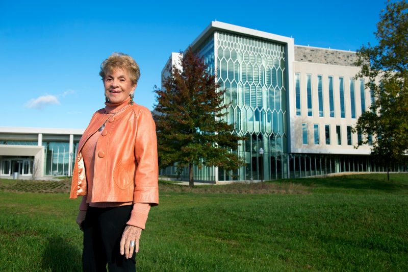 Patricia Buckley Moss - in memoriam A woman stands in front of a large building on Virginia Tech's Blacksburg campus
