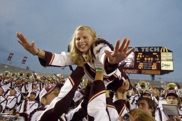 Kelley McNamee is held in the air by band members.