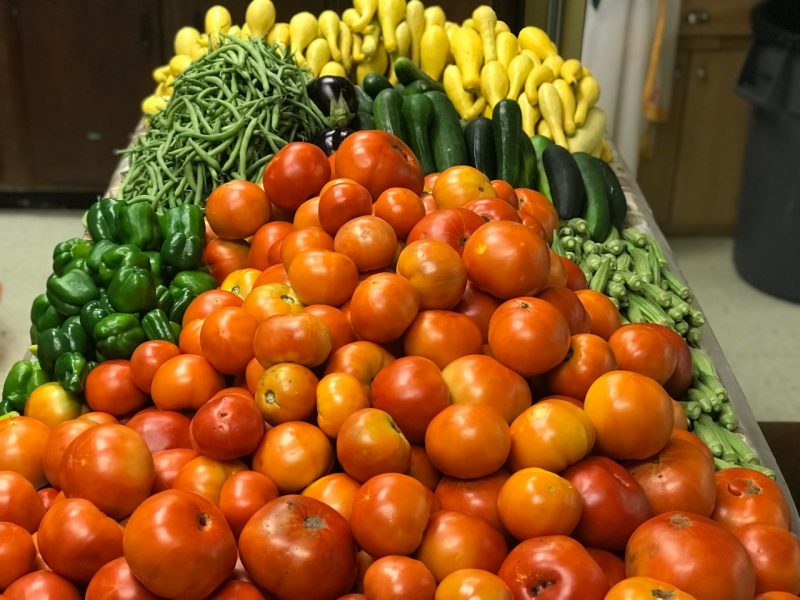 A variety of fresh fuit and vegetables on a table.