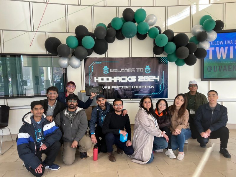 eleven students in front of a banner that says "HooHacks 2024"