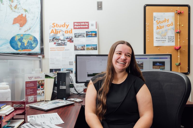 Carly Daffan sits at her desk in the Global Engineering, Engagement, and Research Office
