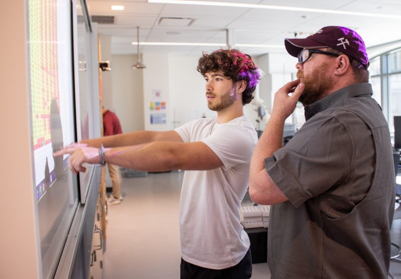 Two researchers looking at a spreadsheet.
