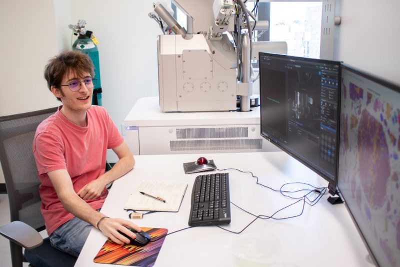 A student looking at research on a computer.