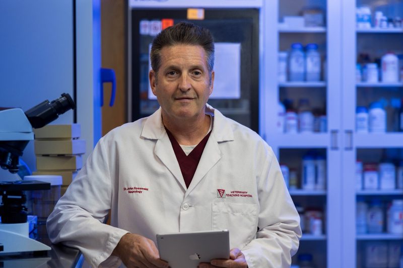 John Rossmeisl in a white lab coat in his lab.