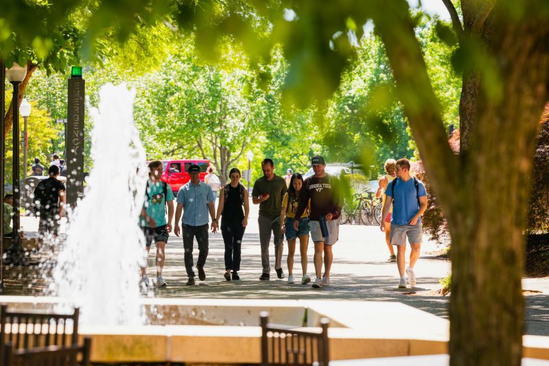 students walking by water feature outside