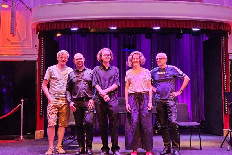 Jacob Alan Smith and PHACE Ensemble Five people stand in a line on a stage