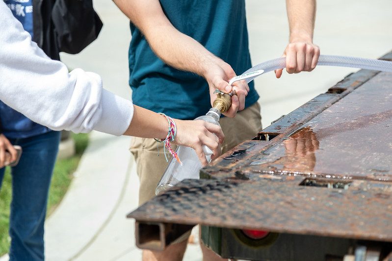 people using a water refill station