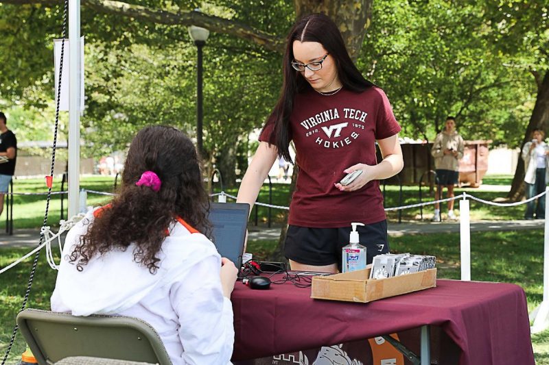New Virginia Tech student swipes Hokie Passport card for validation.
