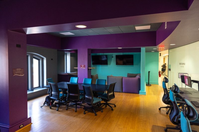 a wide view of the purple and teal gaming studio space
