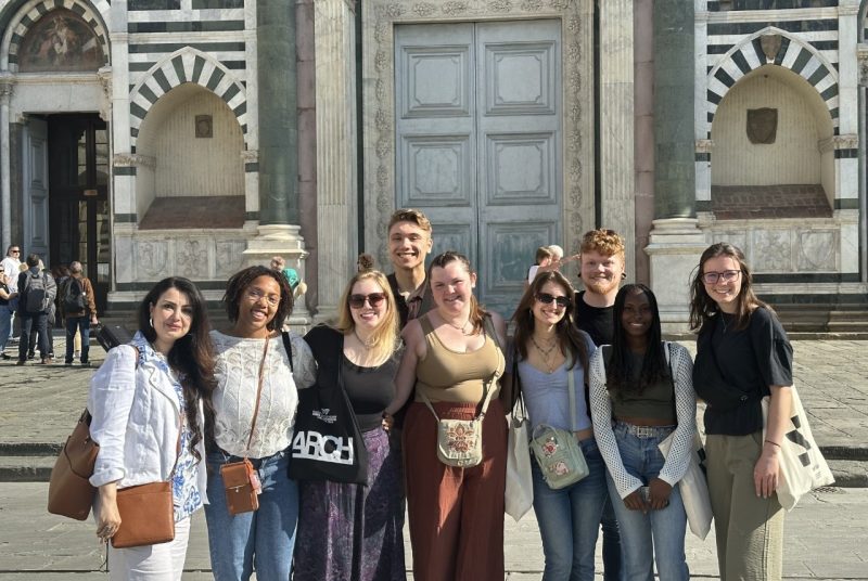 Ethan Greenough Overseas Study A group of students poses for a photo in front of a marble building with a large door.