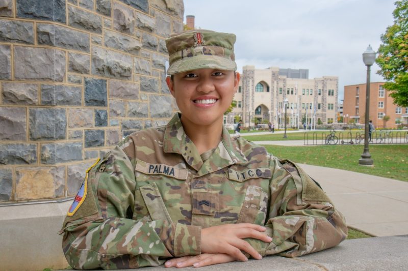 person in military fatigues outside