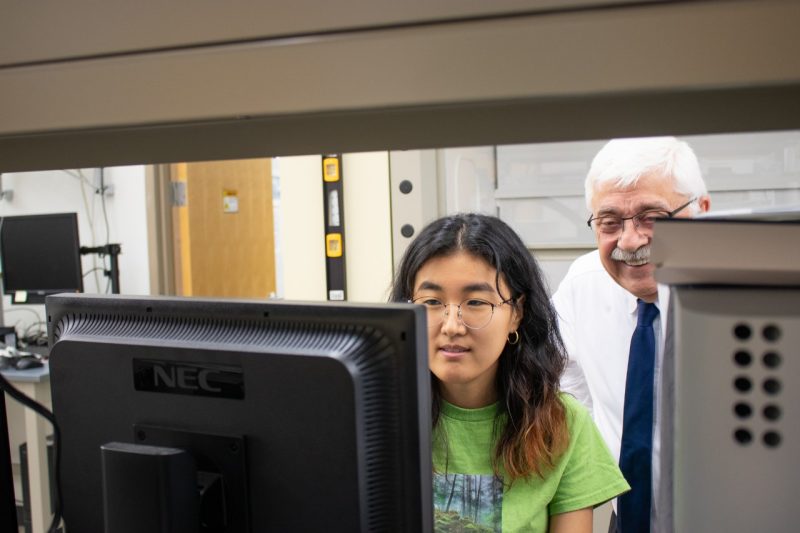 Two researchers looking at a computer screen.