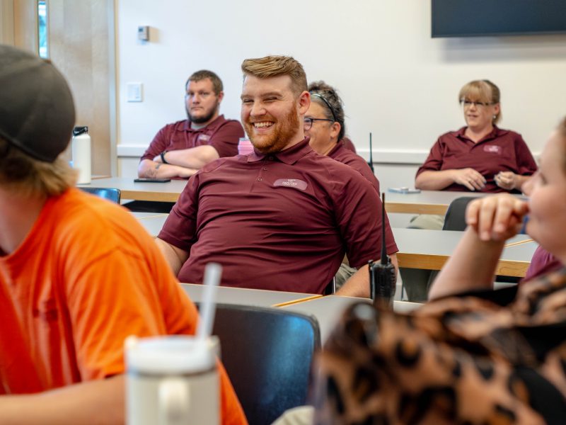 Custodial Services employees sit at tables in the Sterrett Classroom during a luncheon