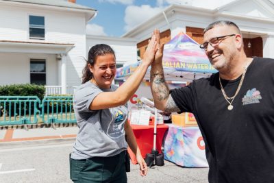 Elli and a food truck vendor high five.