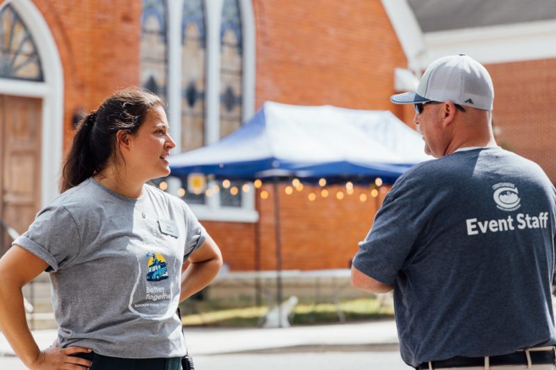 Elli speaks to a Town of Christiansburg employee who is also event staff for the food truck rodeo while standing in the middle of downtown.