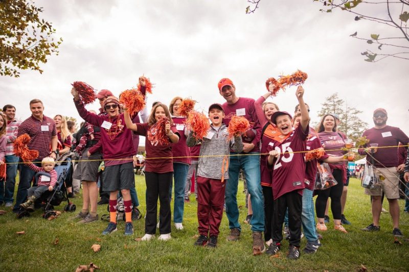 Hokies fans cheering at Holtzman Alumni Center