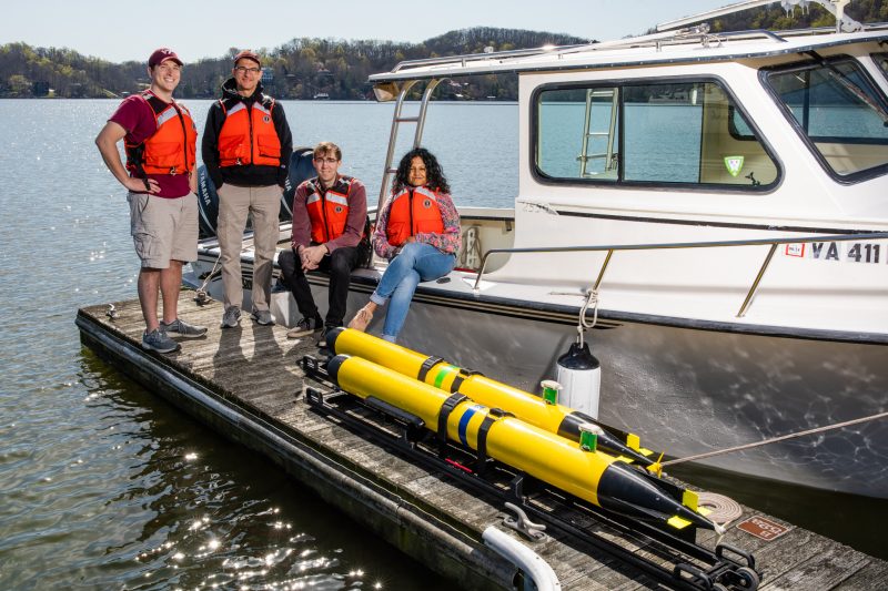 Research team poses in front of boat at Claytor Lake