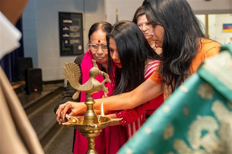 Special guests lighting the ceremonial lamp to start the evening's celebration. Photo by A’me Dalton for Virginia Tech.