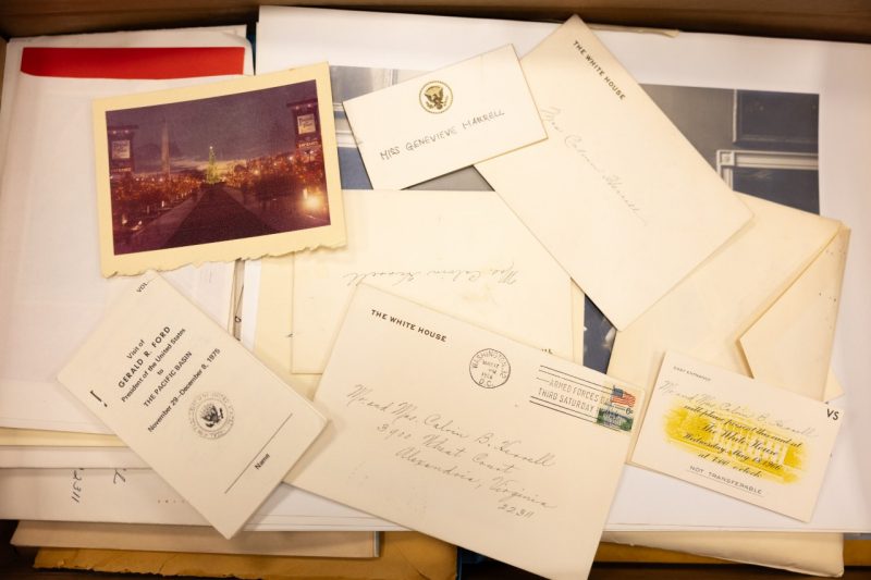 A photo of invitations to White House Dinners and photographs from the White House.