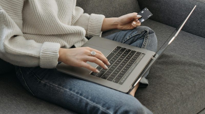 A woman shopping online with laptop and credit card. Photo courtesy Pexels.