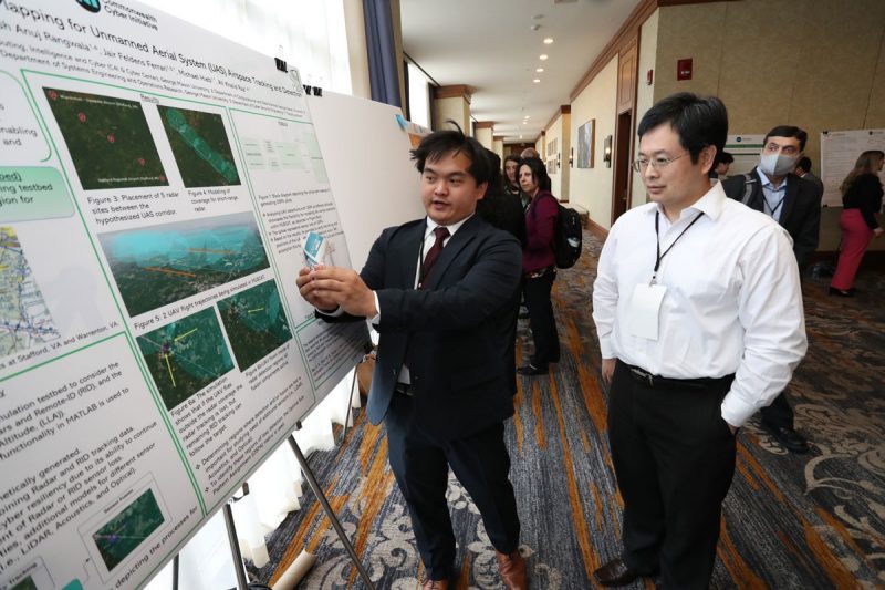 CCi rsearcher Yi Shi listens to a student discuss his research CCi rsearcher Yi Shi listens to a student discuss his research