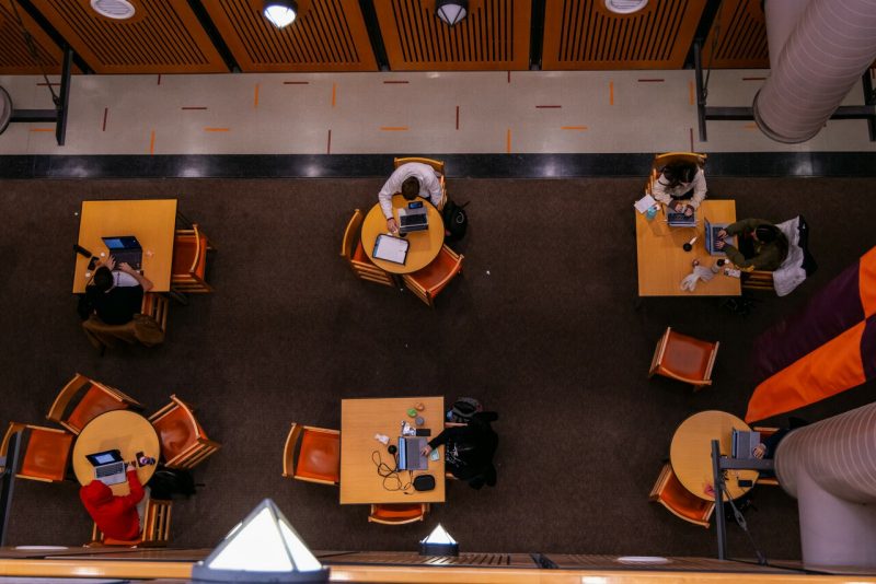 Students studying Overhead view of students working at tables during finals week.